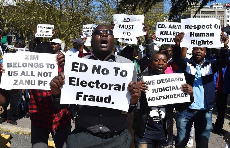 Zimbabweans living in South Africa protest outside the World Economic Forum on Africa in Cape Town, South Africa, Wednesday, Sept. 4, 2019. Zimbabwean President Emerson Mnangagwa is attending the three-day summit that will tackle the issues faced by the continent by focusing on how to scale up the transformation of regional architecture related to smart institutions, investment, integration, industry and innovation. (AP Photo)