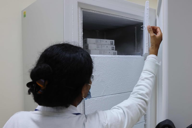A nurse opens a freezer at Barsha Health Centre. The Pfizer-BioNTech vaccine must be kept at minus 70C when transported.