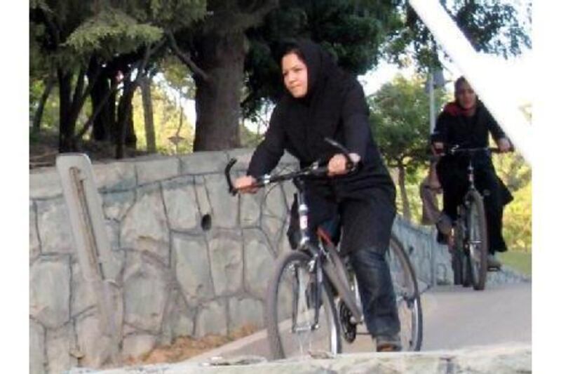 Iranian women ride their bicycles at Tehran's "Mothers' Paradise" park, which is the Iranian capital's women-only public recreation area.