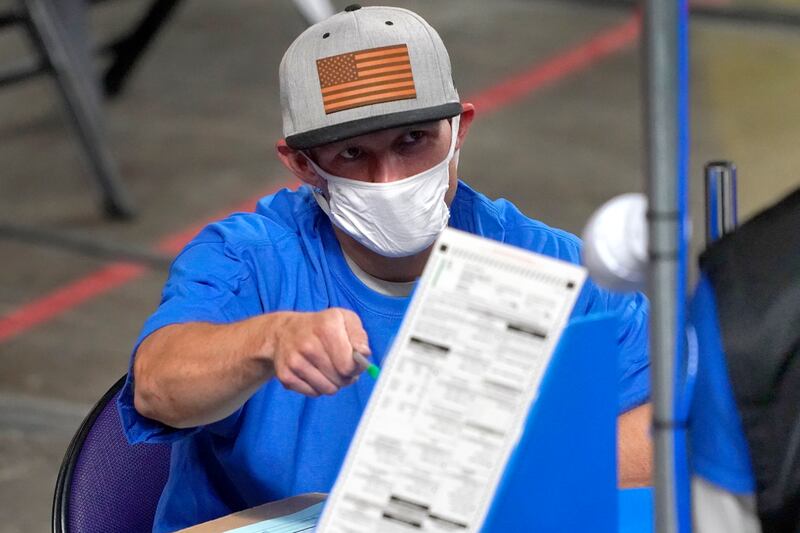 Maricopa County ballots cast in the 2020 general election are examined and recounted by contractors working for Florida-based company Cyber Ninjas at Veterans Memorial Coliseum in Phoenix. AP Photo / Matt York, Pool