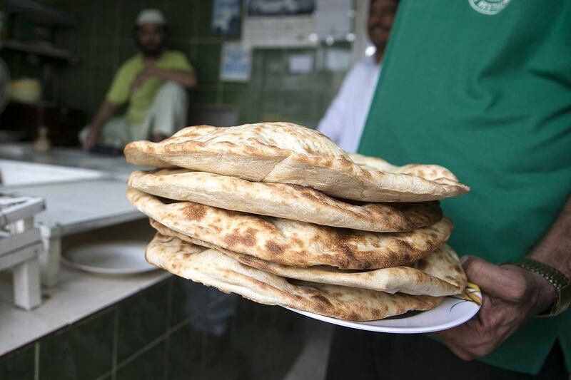 Freshly baked flat bread from the Ghazi bakery in central Abu Dhabi, made with subsidised flour. Silvia Razgova / The National