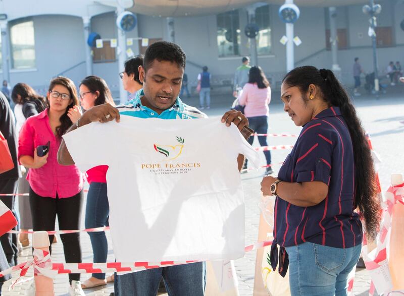 DUBAI, UNITED ARAB EMIRATES -Faithfuls trying out their Papal souvenirs at St. Mary's Catholic Church, Oud Mehta.  Leslie Pableo for The National for Anam Rizvi's story