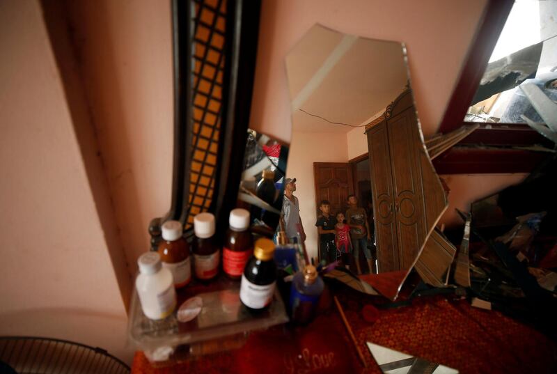 Palestinians inspect a house that was damaged in an Israeli air strike in Al-Mughraqa. Reuters