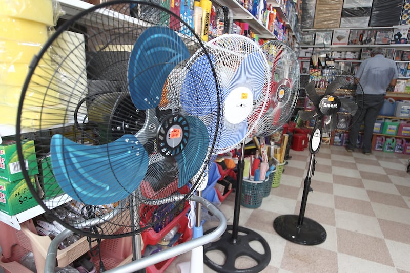 Fans in a general store in Algiers where the temperatures rose up to 30 degrees Celsius. AP