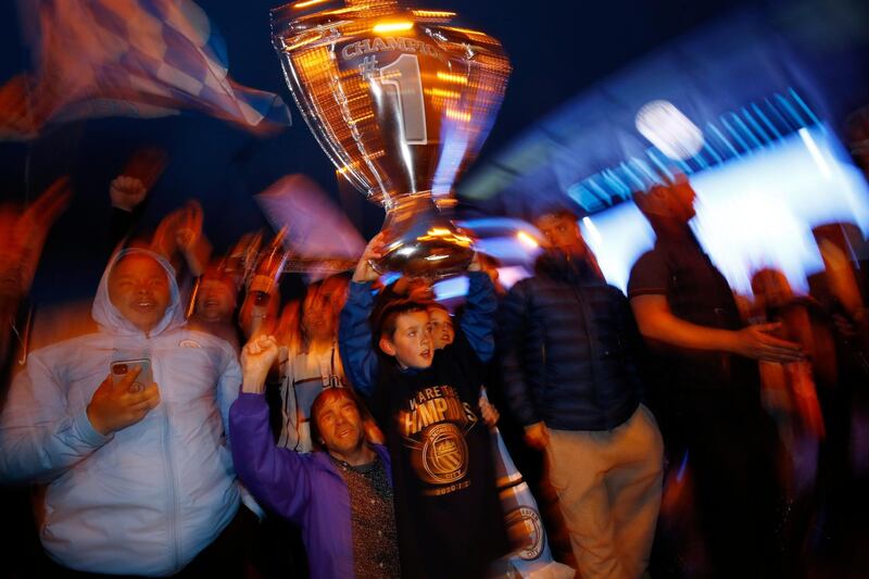 Manchester City fans celebrate winning the Premier League. Reuters