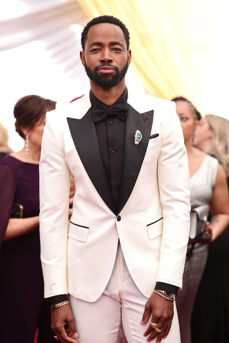 Actor Jay Ellis wears a white tuxedo. AFP