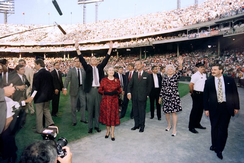 George Bush, the US president at the time, and the queen wave to the crowd before the start of the Orioles v Oakland Athletics baseball game in Baltimore, Maryland, on May 15, 1991. AFP