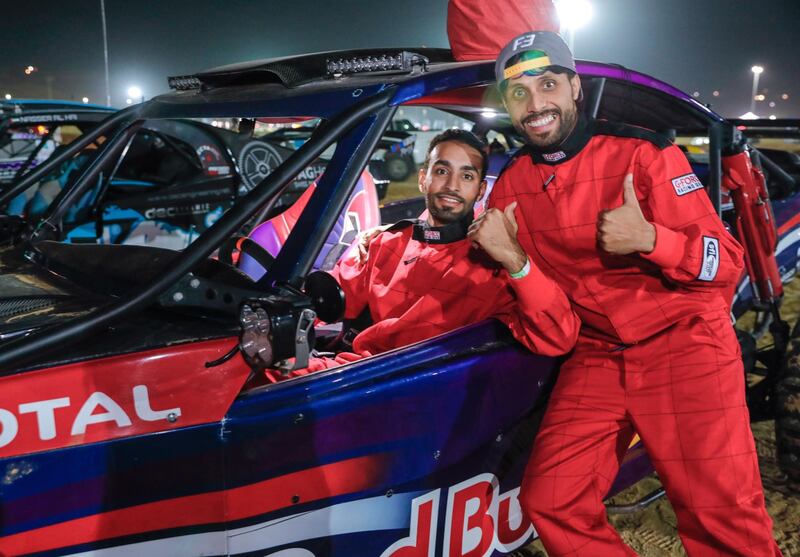 Abu Dhabi, United Arab Emirates, January 2, 2020.  Buggy owner, Nasser Al Hai celebrates, right, with driver, Rashid Al Dhaheri afterr taking first place at the Buggy Race at the LIWA International Festival 2020.
Victor Besa / The National
Section:  NA
Reporter:  Haneen Dajani