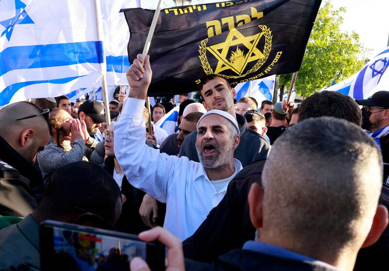 Right-wing Israelis wave national and party flags as they march towards Jerusalem's Tzahal Square. AFP