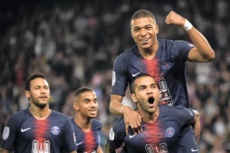 Paris Saint-Germain's Brazilian defender Dani Alves (bot) and Paris Saint-Germain's French forward Kylian Mbappe celebrate after scoring a third goal during the French L1 football match between Paris Saint-Germain (PSG) and Monaco (ASM) on April 21, 2019 at the Parc des Princes stadium in Paris. (Photo by Anne-Christine POUJOULAT / AFP)