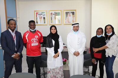 The Medical fees for four premature babies have been covered by the Crown Prince of Dubai. From left, family representative Abdul Hakeem Anifowoshe, father Tijani Abdulkareem, hospital chief executive Dr Muna Abdul Razzaq Tahlak, head of finance Mr Abbas, mother Suliyat Abdulkareem and Virginia Roque, one of the community members who have supported the family. Courtesy: Abdulkareem family 
