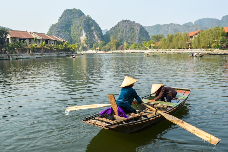 A row boat prepares to collect tourists for a tour through Tam Coc.