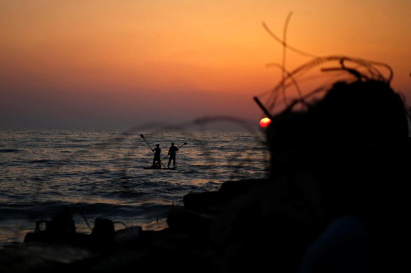 Palestinians ride a boat in the Mediterranean Sea in the northern Gaza Strip. Reuters