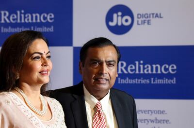 FILE- In this Aug. 12, 2019 file photo, Chairman of Reliance Industries Limited Mukesh Ambani, center, with wife Neeta Ambani arrives for 42nd Annual General Meeting of Reliance Industries Limited in Mumbai, India. Facebook says it plans to invest $5.7 billion in Indiaâ€™s telecom giant Reliance Jio. The investment will give Facebook a 9.99% stake in Jio Platforms, the digital technologies and app developing division of Reliance Industries. Ambani, Relianceâ€™s head and Indiaâ€™s richest man, said that he is â€œhumbledâ€ to have Facebook as a long-term partner, and that the investment will help propel Indiaâ€™s digital push forward. (AP Photo/Rajanish Kakade, File)