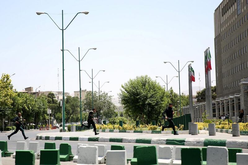 Iranian police run towards the parliament building. Ali Khara / EPA