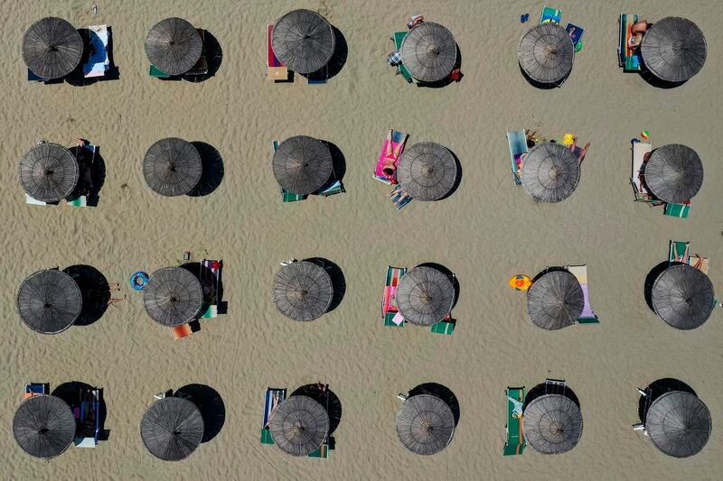 This aerial view shows parasols on a beach by the Adriatic Sea in Durres, Albania, as a heatwave sweeps through Europe. AFP