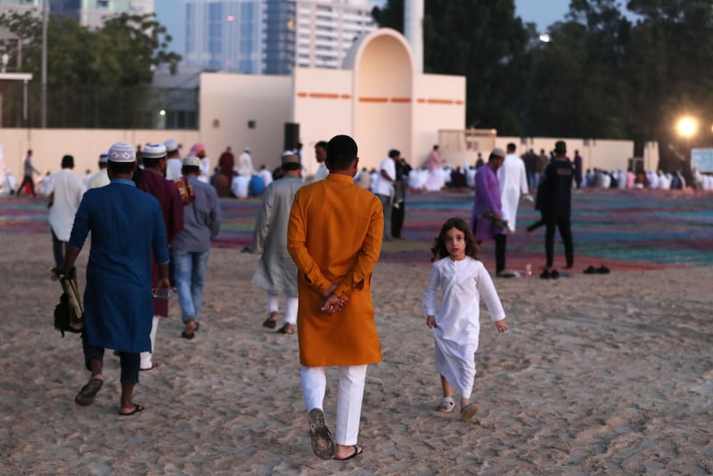 People arrive for morning prayers in Al Barsha on Friday. Chris Whiteoak / The National
