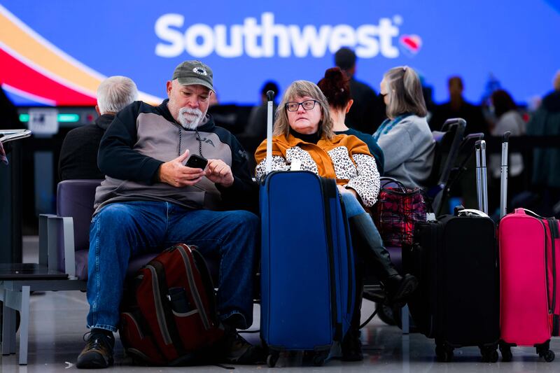 A couple wait for a flight at Denver International Airport. AFP