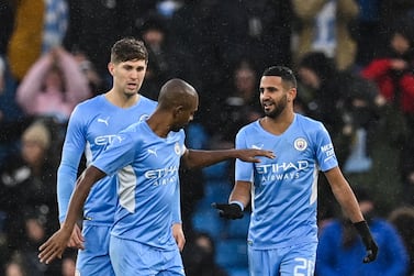 Manchester City's Algerian midfielder Riyad Mahrez (R) celebrates with teammates after scoring a goal during the English FA Cup fourth round football match between Manchester City and Fulham at the Etihad Stadium in Manchester, north west England, on February 5, 2022. (Photo by Paul ELLIS / AFP) / RESTRICTED TO EDITORIAL USE. No use with unauthorized audio, video, data, fixture lists, club/league logos or 'live' services. Online in-match use limited to 120 images. An additional 40 images may be used in extra time. No video emulation. Social media in-match use limited to 120 images. An additional 40 images may be used in extra time. No use in betting publications, games or single club/league/player publications. / 