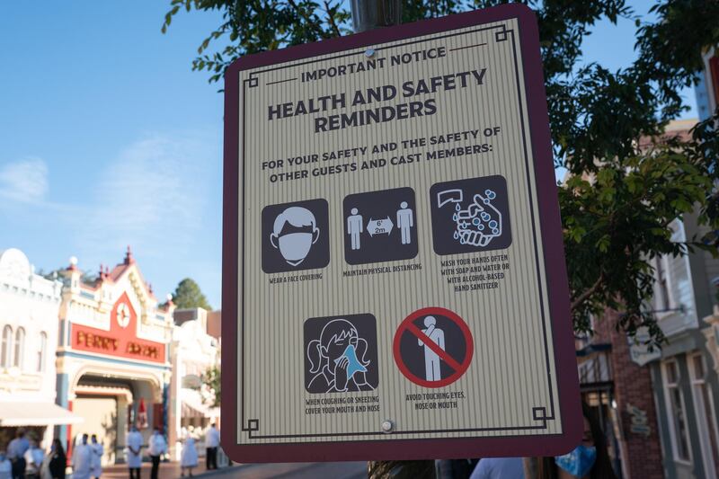 A health and safety reminders sign on Main Street USA during the reopening of the Disneyland theme park in Anaheim, California, U.S., on Friday, April 29, 2021. Walt Disney Co.'s original Disneyland resort in California is sold out for weekends through May, an indication of pent-up demand for leisure activities as the pandemic eases in the nation's most-populous state. Photographer: Bing Guan/Bloomberg