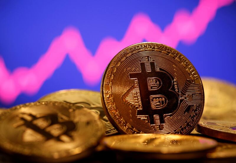 FILE PHOTO: FILE PHOTO: A representation of virtual currency Bitcoin is seen in front of a stock graph in this illustration taken January 8, 2021. REUTERS/Dado Ruvic/File Photo