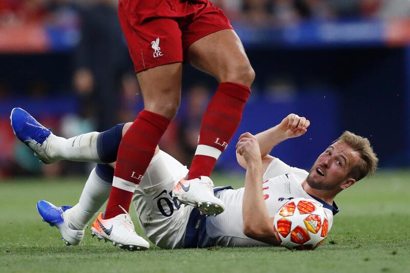 Tottenham's Harry Kane lies on the ground as Liverpool's Virgil Van Dijk controls the ball. AP