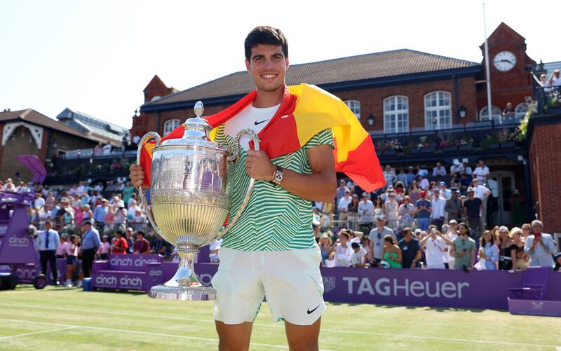 Carlos Alcaraz of Spain poses with the winner's trophy after victory against Alex De Minaur of Australia in the men's singles final at Queen's Club on June 25, 2023 in London, England. Getty Images