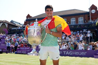 LONDON, ENGLAND - JUNE 25: Carlos Alcaraz of Spain poses with the winner's trophy after victory against Alex De Minaur of Australia in the Men's Singles Final match on Day Seven of the cinch Championships at The Queen's Club on June 25, 2023 in London, England. (Photo by Luke Walker / Getty Images for LTA)