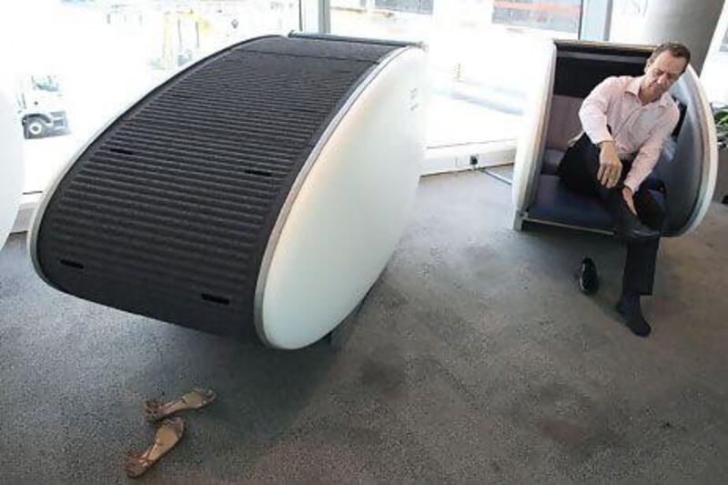 A passenger sits in a Go Sleep pod at Abu Dhabi's airport. For now, the napping stations are free on a first-come, first-serve basis. Delores Johnson / The National