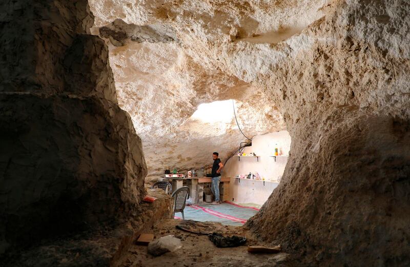 Ahmed Amarneh stands by a tap at the kitchen of the home he built in cave in Farasin, a village west of Jenin in the northern occupied West Bank. AFP