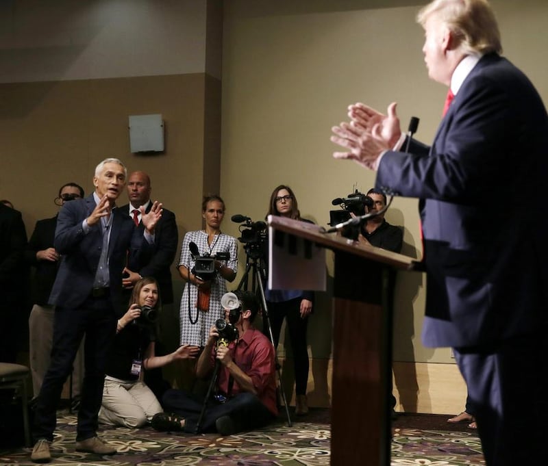 Miami-based Univision anchor Jorge Ramos asks Republican presidential candidate Donald Trump a question about his immigration proposal during a news conference in Dubuque, Iowa. Ramos was later removed from the room. Charlie Neibergall / AP Photo