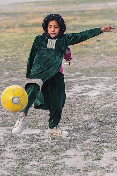 A girl plays football at a square in Kabul on June 23, 2021. / AFP / ADEK BERRY
