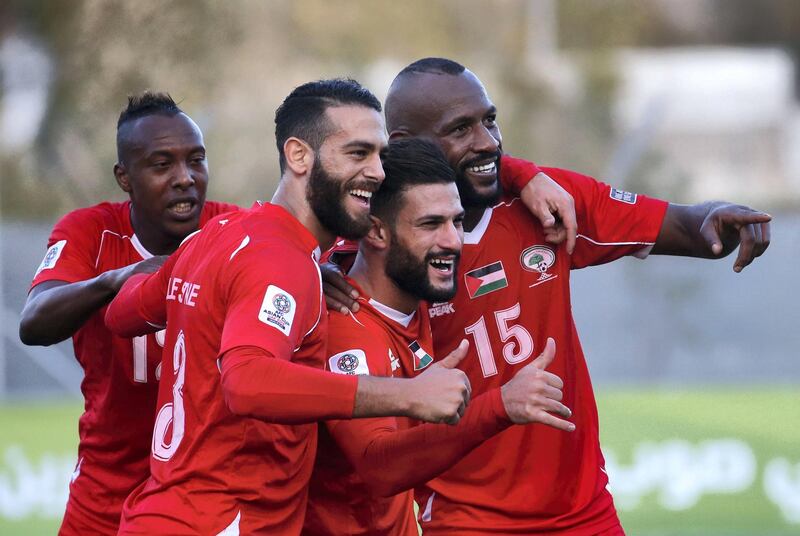 Palestine's players celebrate after scoring a goal during the Asian Cup 2019 qualifier football match between Bhutan and Palestine, on October 10, 2017, in the West Bank city of Hebron.
Palestine won 10-0. / AFP PHOTO / HAZEM BADER