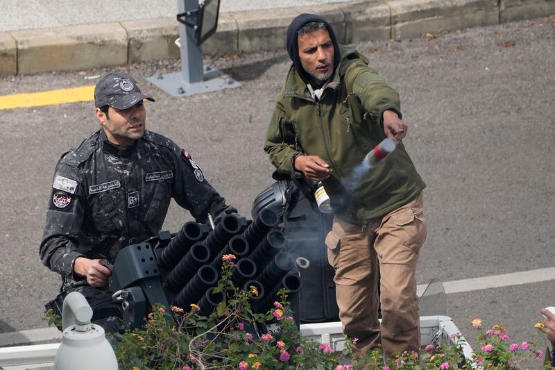 Lebanese soldiers use tear gas against retired servicemen during the protest. AP