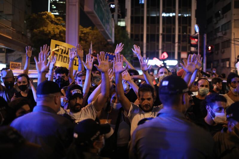 Israeli border police confronts protesters during a self-employed business owners demonstration against the Israeli government in Rabin square in Tel Aviv.  EPA