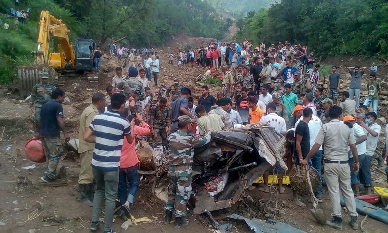 Rescuers search for bodies n in Urla village, Himachal Pradesh state. Shailesh Bhatnagar / AP Photo