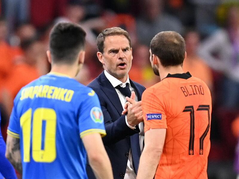 Netherlands coach Frank de Boer shakes hands with Daley Blind after being substituted. Reuters