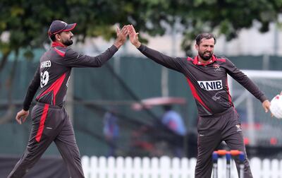 DUBAI, UNITED ARAB EMIRATES , Dec 15– 2019 :- Rohan Mustafa (right) of UAE celebrating after taking the wicket of Stuart Whittingham during the World Cup League 2 cricket match between UAE vs Scotland held at ICC academy in Dubai. Rohan Mustafa took 3 wicket in this match. ( Pawan Singh / The National )  For Sports. Story by Paul