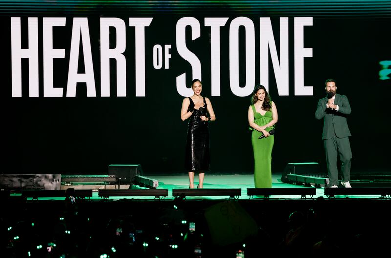 From left: Gal Gadot, Alia Bhatt and Jamie Dornan speak during Netflix's Tudum: A Global Fan Event 2023 in Sao Paulo, Brazil. All photos: Getty Images