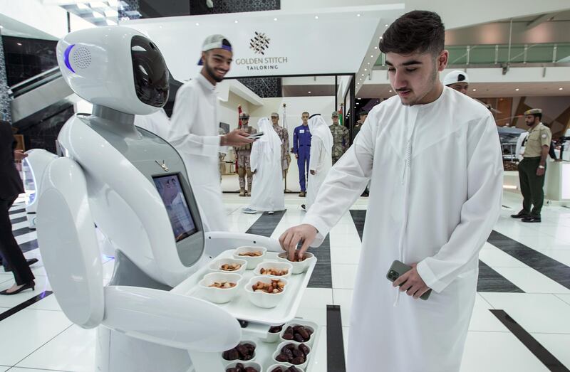 Abu Dhabi, United Arab Emirates, February 24, 2020.  The Unmanned Systems Exhibition and Conference (UMEX 2020) and Simulation Exhibition and Conference (SimTEX 2020).
--  A UMEX 2020 robot welcomes guests with nuts and dates.
Victor Besa / The National
Section:  NA
Reporter:  None