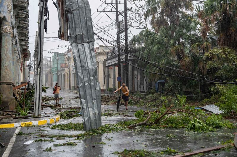 Fallen electricity lines, metal and tree branches litter a street after Hurricane Ian hit Pinar del Rio, Cuba. AP