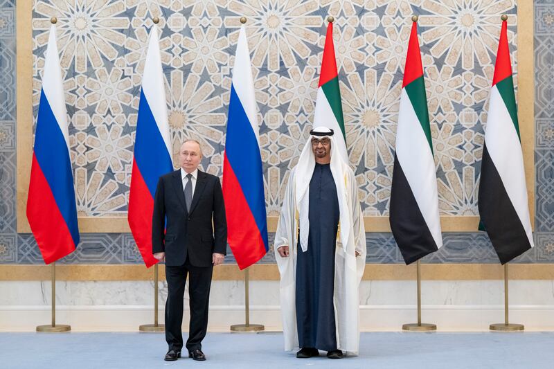 The national flags of the UAE and Russia provide the background for two leaders. Abdulla Al Bedwawi / Presidential Court