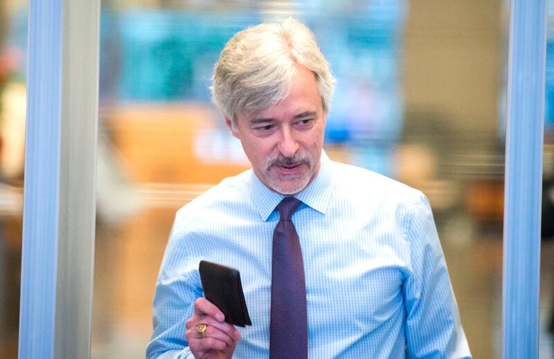 Waymo CEO John Krafcik shows his wallet has he arrives at the Phillip Burton Federal Building and United States Courthouse for the start of the Waymo vs. Uber trial in San Francisco, California on February 05, 2018. 
The billion-dollar trial pitting Alphabet-owned autonomous driving unit Waymo against Uber started in what could be a blockbuster case between two technology giants over alleged theft of trade secrets. The San Francisco courtroom battle will take place as Waymo and Uber race to perfect self-driving cars that people could summon for rides as desired in a turn away from car ownership.
 / AFP PHOTO / JOSH EDELSON