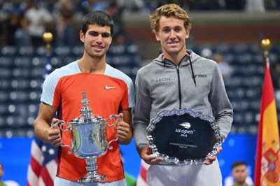 Spain's Carlos Alcaraz, left, and Norway's Casper Ruud pose with their trophies after their 2022 US Open Tennis tournament men's singles final in New York on Sunday. AFP