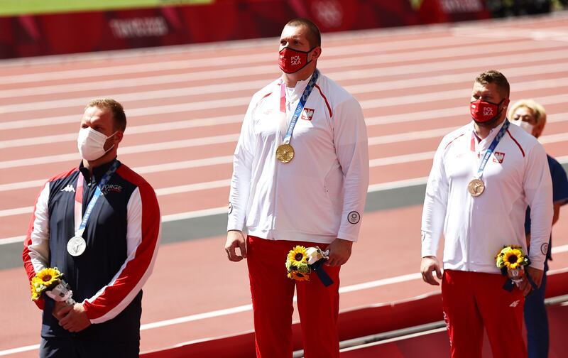 Gold medalist Wojciech Nowicki, centre, of Poland, silver medalist Eivind Henriksen, left, of Norway and bronze medalist Pawel Fajdek of Poland during the medal ceremony for the men's Hammer Throw.