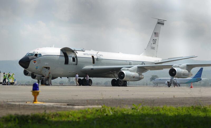 Crew members of a US Air Force WC-135 'Constant Phoenix', a special-purpose aircraft used to detect nuclear explosions by analysing air samples from the atmosphere, conduct a ground inspection at Sultan Iskandar Muda Airport in Aceh Besar, Aceh province, on March 25, 2017, after making an emergency landing the day before. - Indonesia's government news agency reported on March 25 that the base commander said the aircraft, carrying some 20 crew members, made an emergency landing on March 24 after reporting a problem with one of its four engines. (Photo by CHAIDEER MAHYUDDIN / AFP)