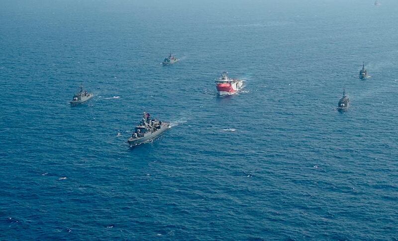 Turkey's research vessel, Oruc Reis, center, is surrounded by Turkish navy vessels as it was heading in the west of Antalya on the Mediterranean, Turkey. AP