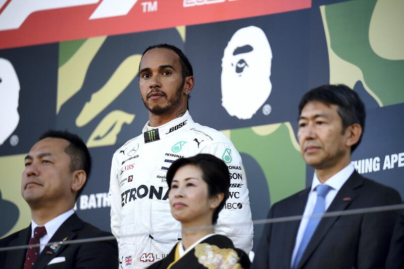 SUZUKA, JAPAN - OCTOBER 13: Third placed Lewis Hamilton of Great Britain and Mercedes GP looks on, on the podium during the F1 Grand Prix of Japan at Suzuka Circuit on October 13, 2019 in Suzuka, Japan. (Photo by Clive Mason/Getty Images)