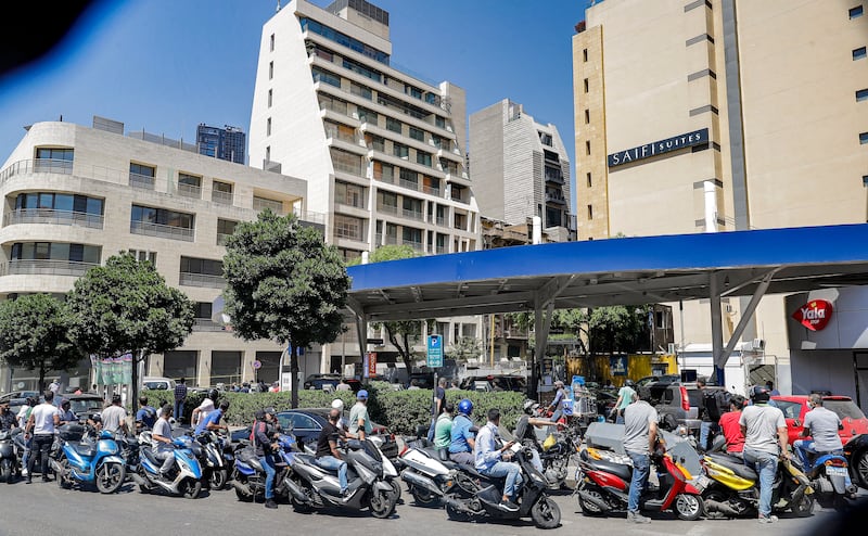 Scooter motorists queue for fuel outside a petrol station in Lebanon's capital Beirut.