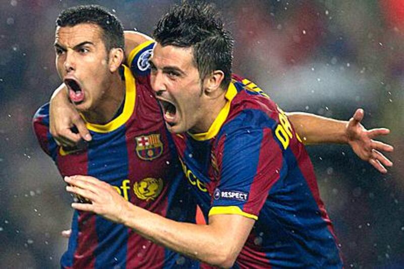 Pedro, left, celebrates scoring the opening goal with Barca teammate David Villa at Camp Nou.